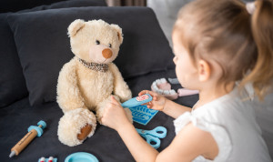 Una niña auscultando a un muñeco.